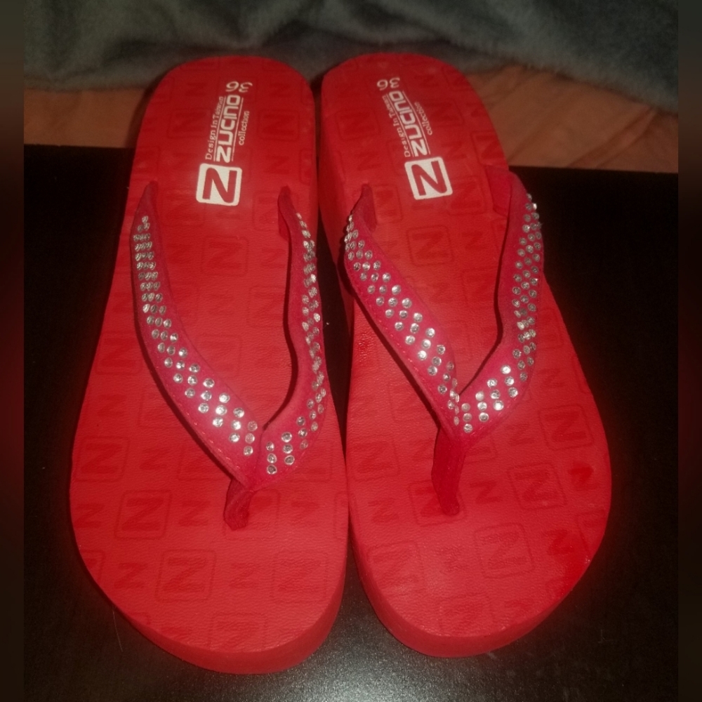 Red rinestone platform flip flops.